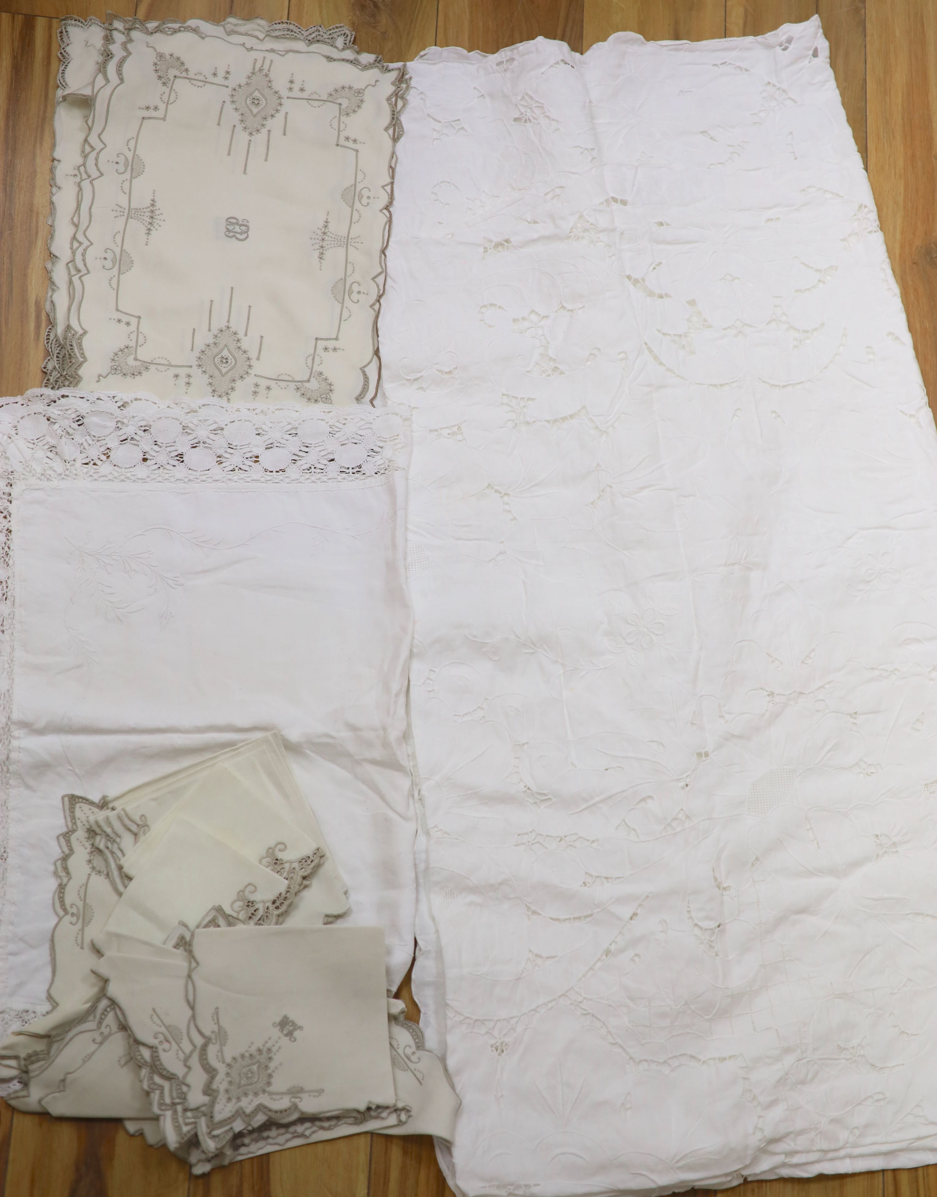 A large cutwork tablecloth, pillowcase plus a napkin and table mat set